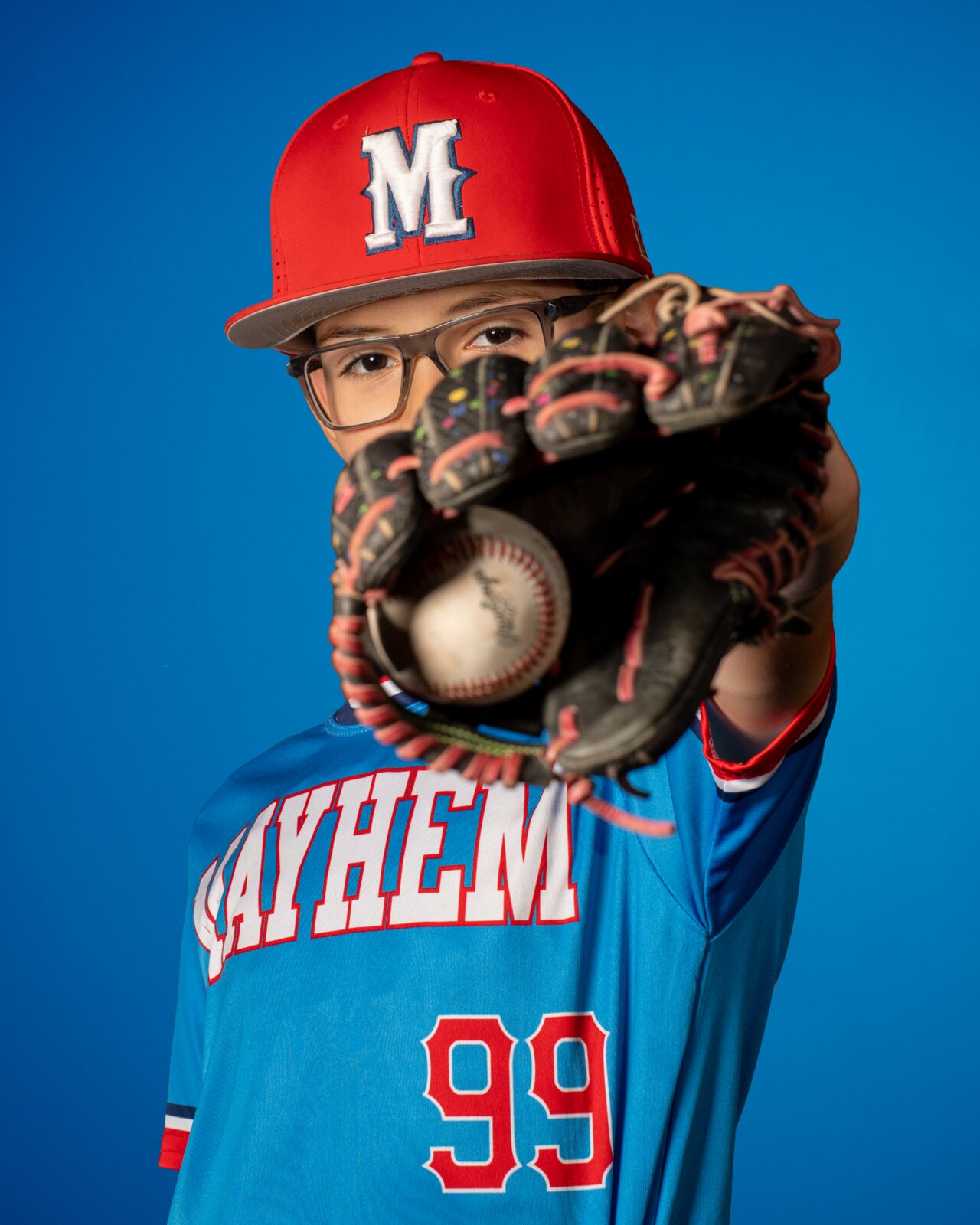 Baseball media day portrait with glove toward camera