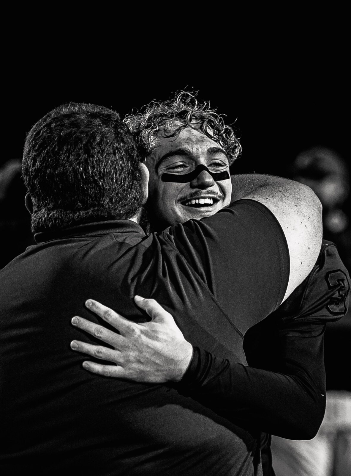 Football player celebrating with a coach