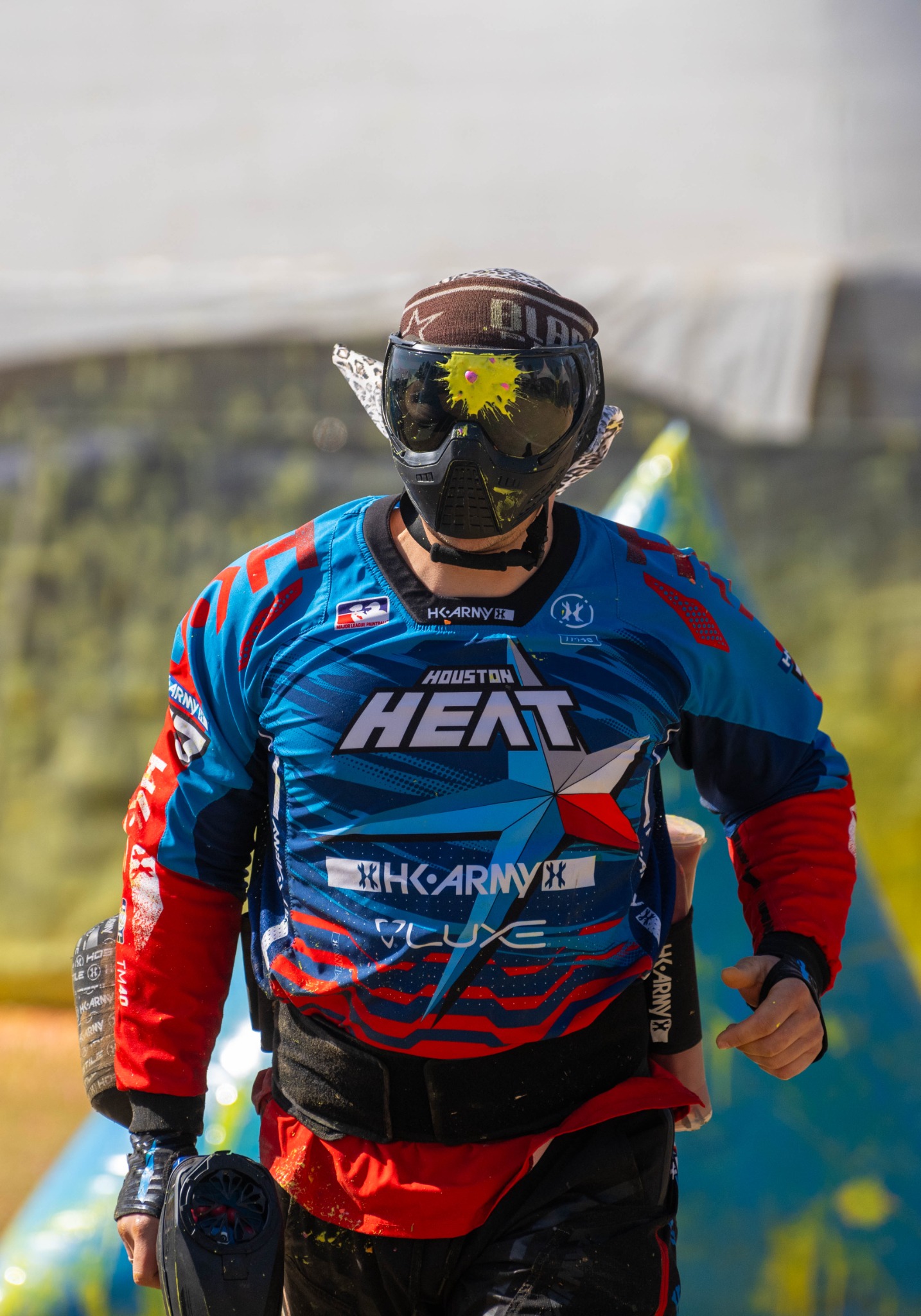 Paintball player with a paint hit on the mask